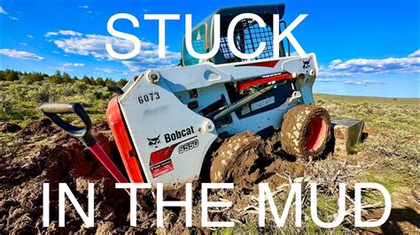 bobcat skid steer stuck in the mud|bob cat kubota skid steer stuck.